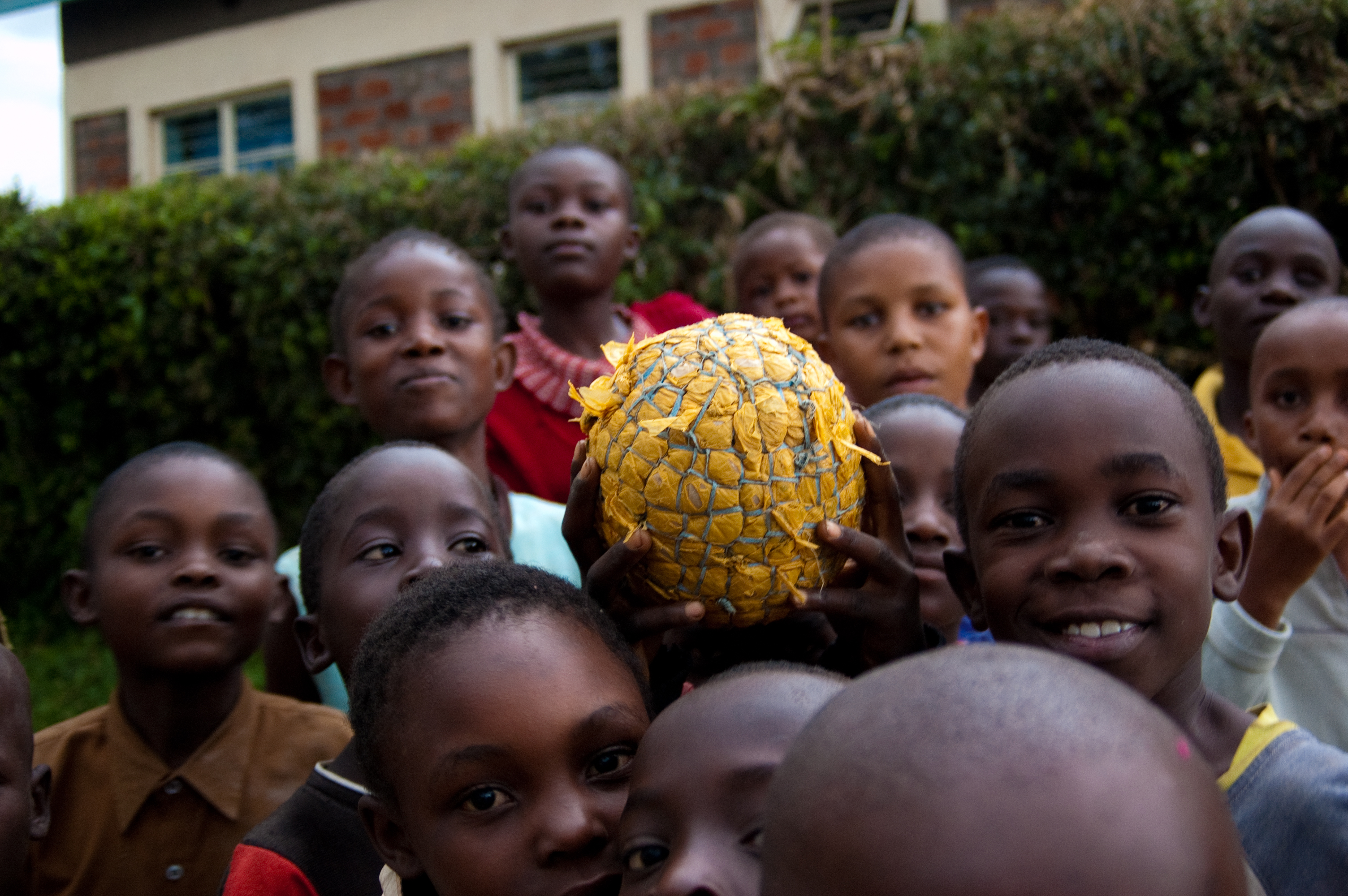 A group of children holds a ball. Photo: PATH/Teresa Guillien