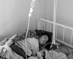 Black and white photo of a mom and baby in a hospital bed