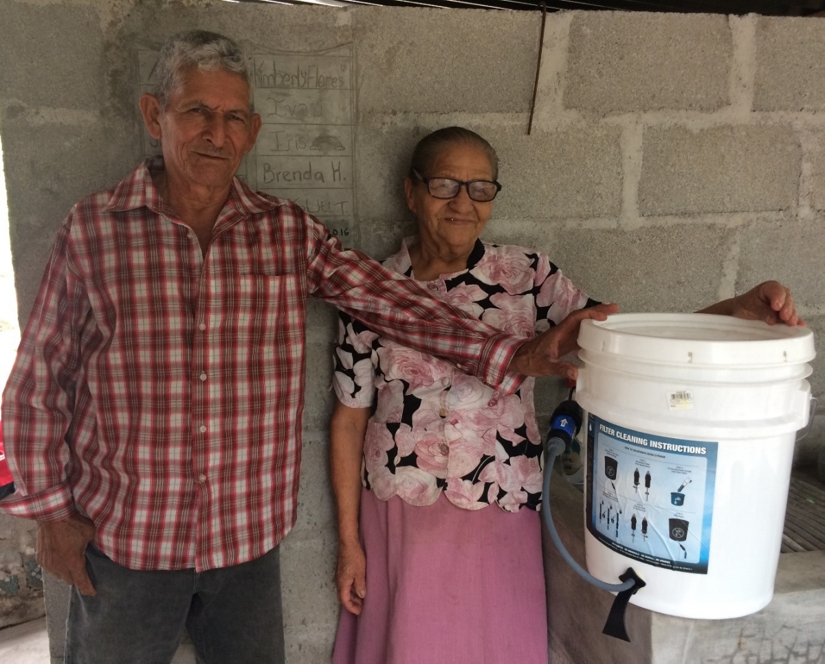 Don Bruno and Doña Adela proudly display their new water filter.
