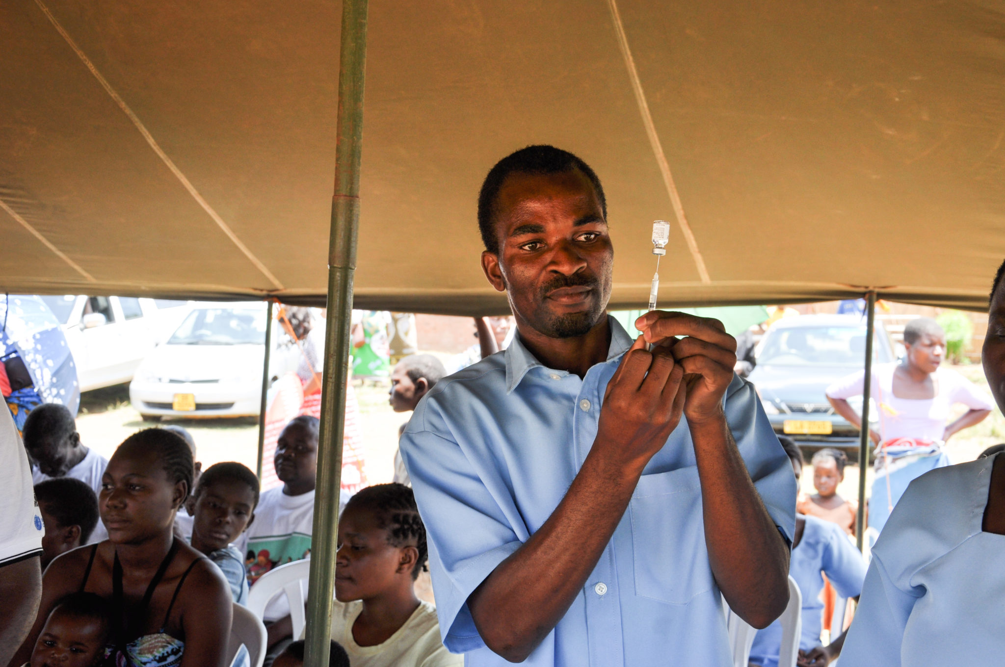 Health worker in Malawi preparing a vaccine