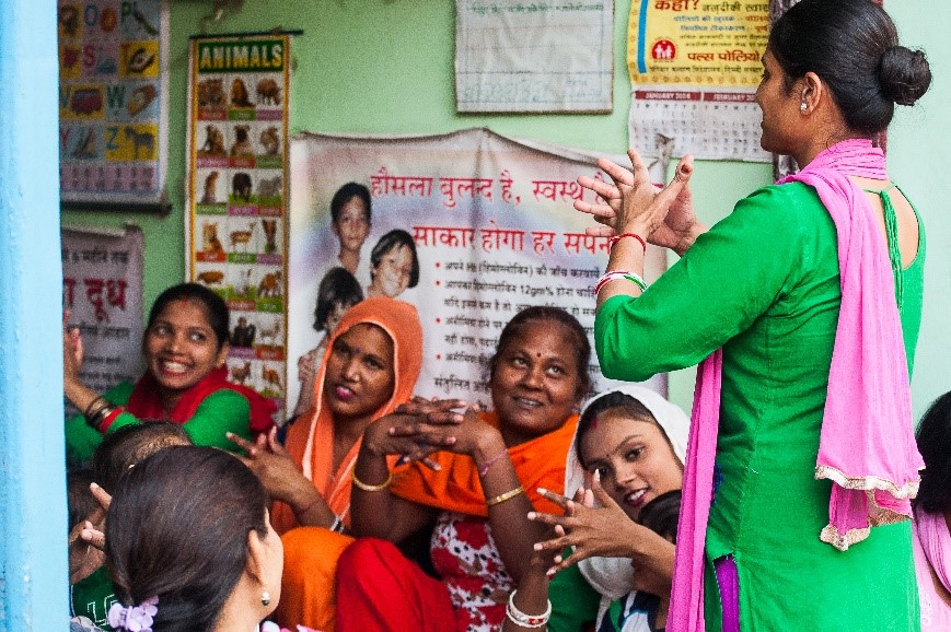 Health worker teaching mothers proper handwashing techniques 
