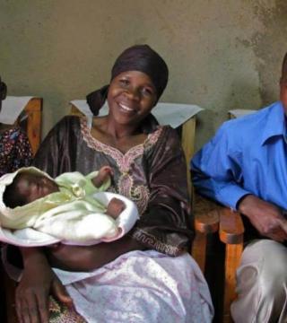 A smiling family with a baby in Rwanda