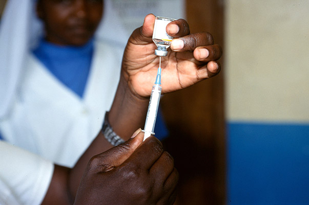 Healthcare worker fills a syringe for injection