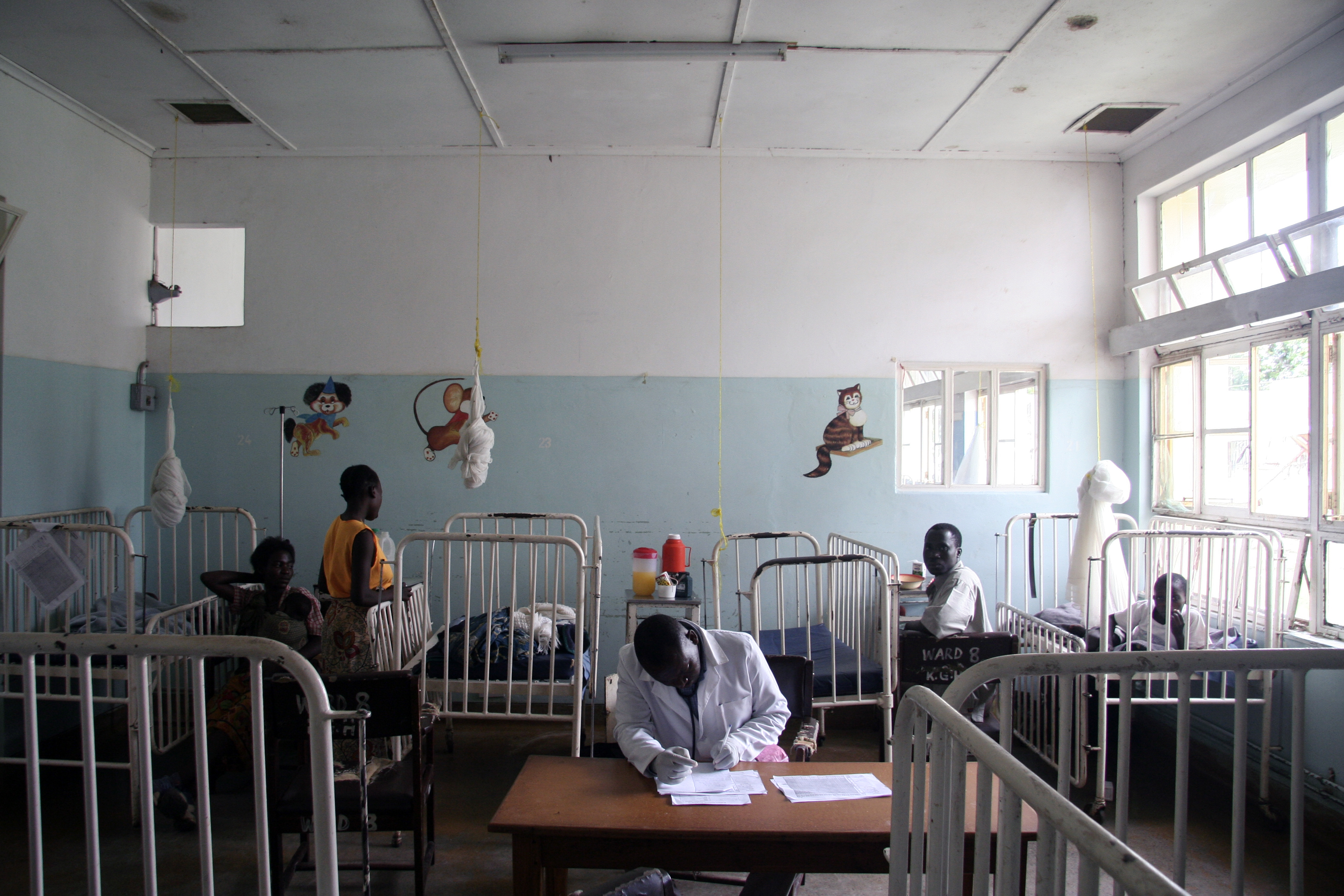A health worker sits at a desk in a clinic in Zambia. PATH/David Jacobs