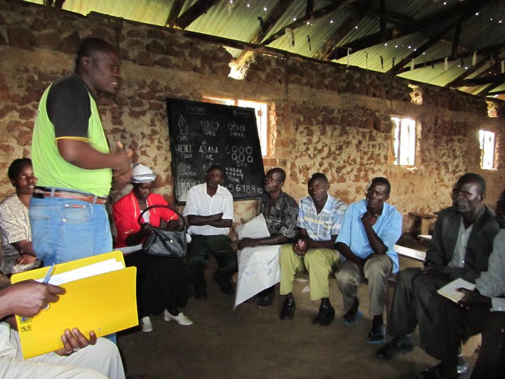 Men's group meets with a community health worker