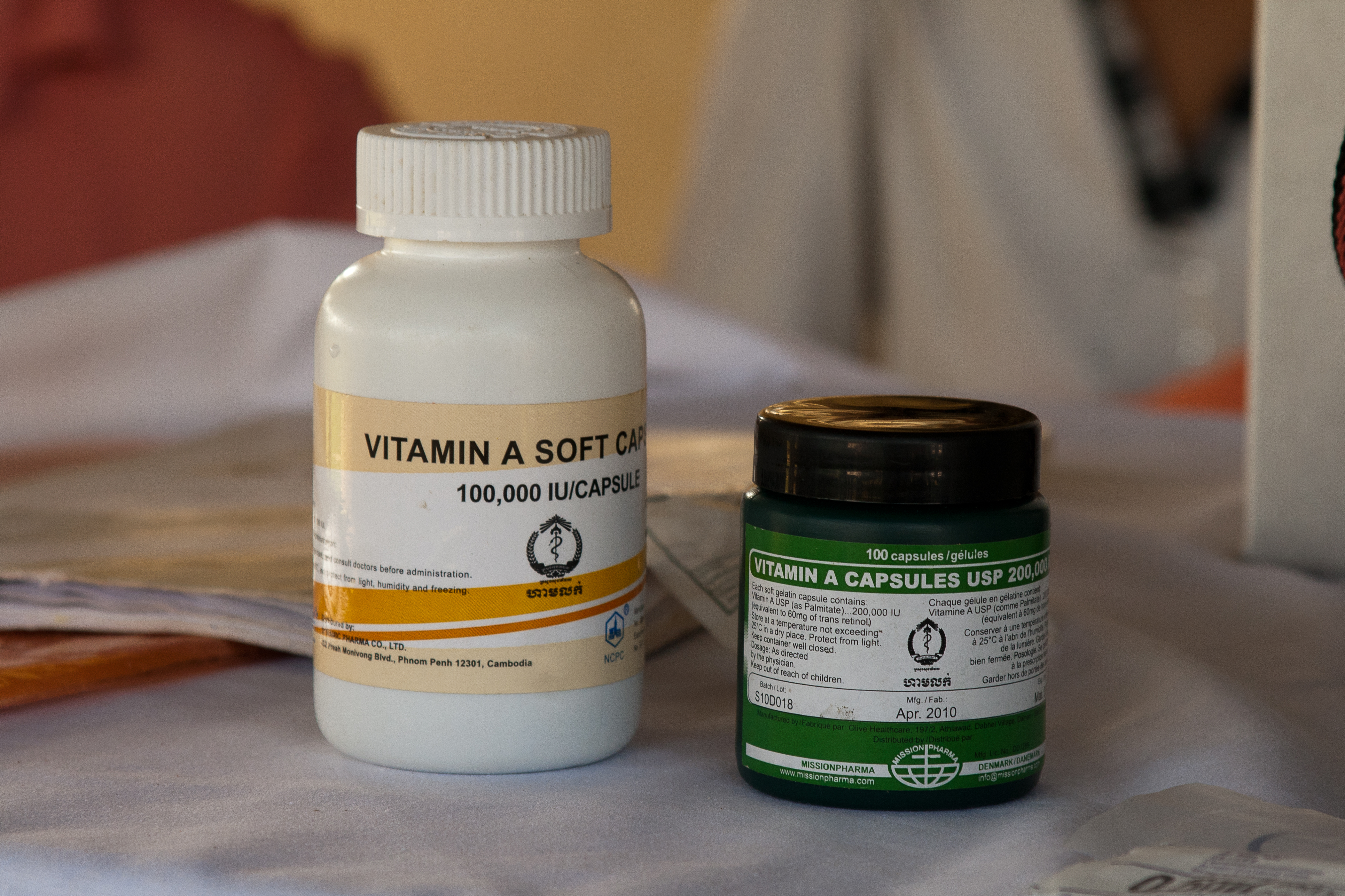 Two bottles of Vitamin A supplements sitting on a counter