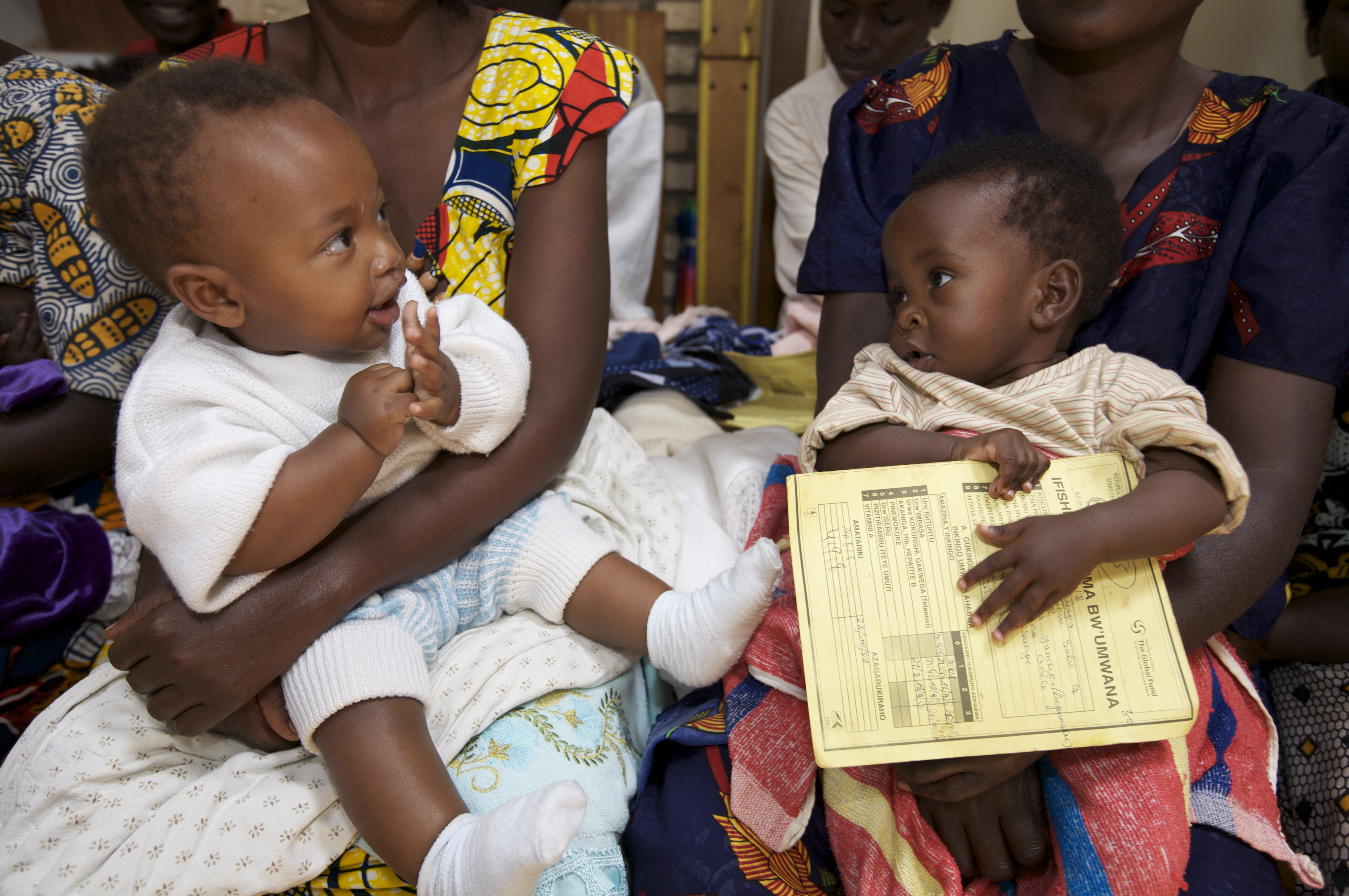 Two young children await their doses of the pneumococcal conjugate vaccine (PCV) in Rwanda.
