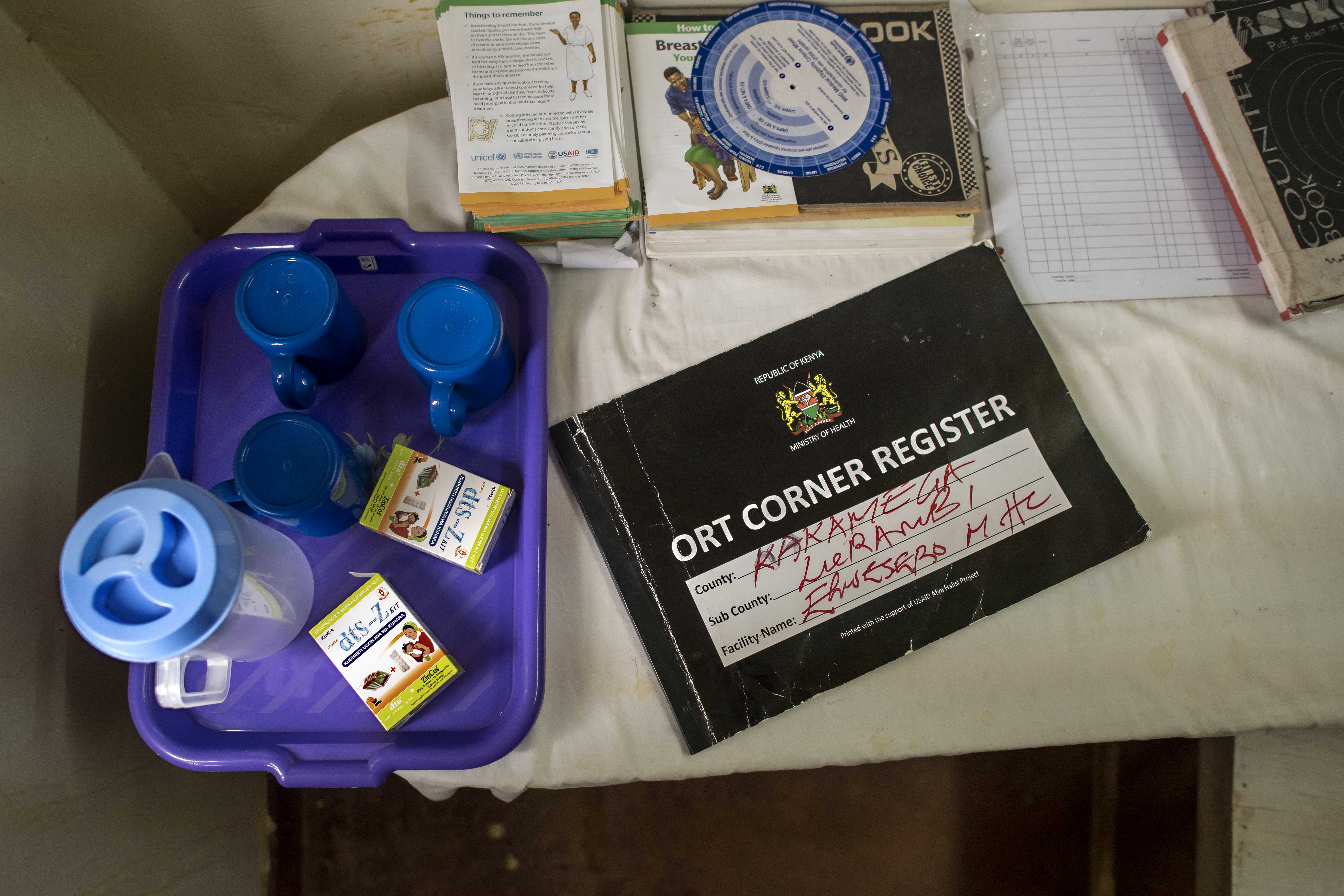 Pitcher, plastic cups, oral rehydration solution and a record keeping book