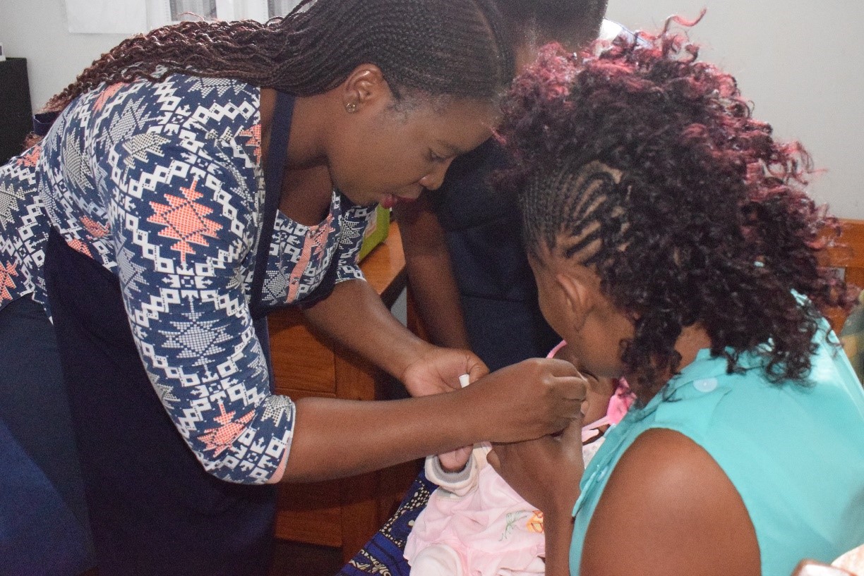 Nurse in Zambia administers ROTAVAC to an infant as part of PATH and CIDRZ clinical study