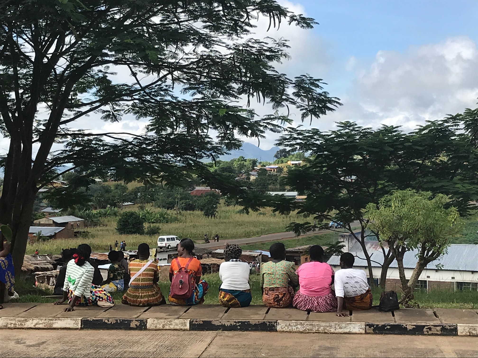 Women sitting outside Chiradzulu Health Center, Malawi