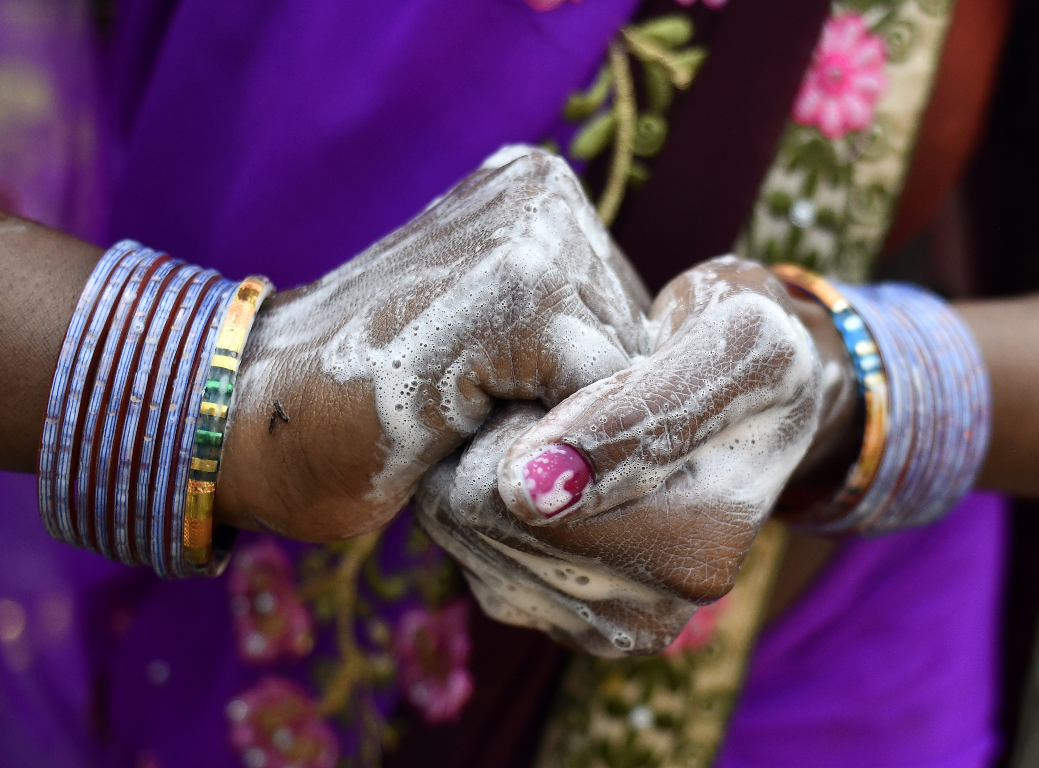 Closeup on woman's hands covered in soap. Photo: UNICEF