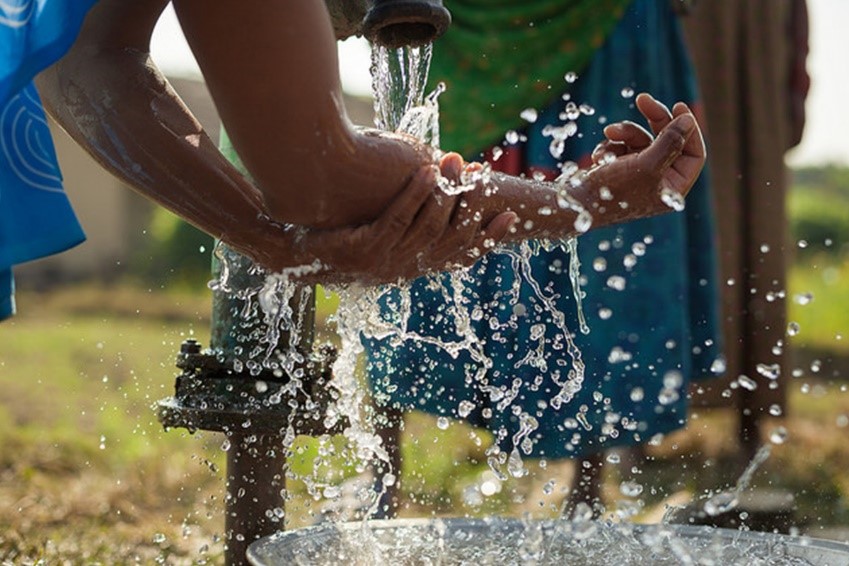 Handwashing at a pump. Credit: USAID