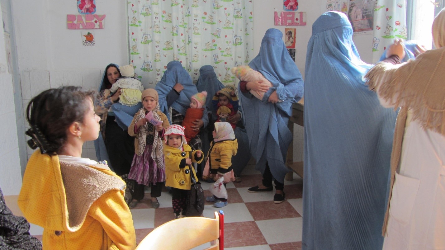 Afghani mothers holding their babies in a hospital waiting room