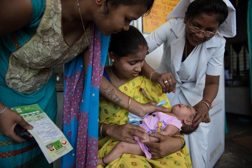 An infant receives an oral rotavirus vaccine.