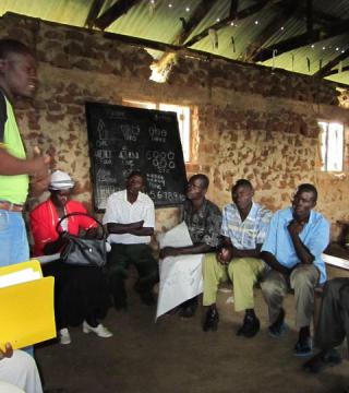 Men's group meets with a community health worker