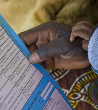 photo of mother holding an immunization card