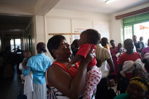 Mother holds daughter at vaccination day event at Gulu Independent Hospital, Uganda