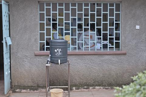 A handwashing station outside of an open window at a local Kenya clinic