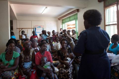 Nurse at Gulu Independent Hospital, Uganda, speaks to women and children at a vaccination event