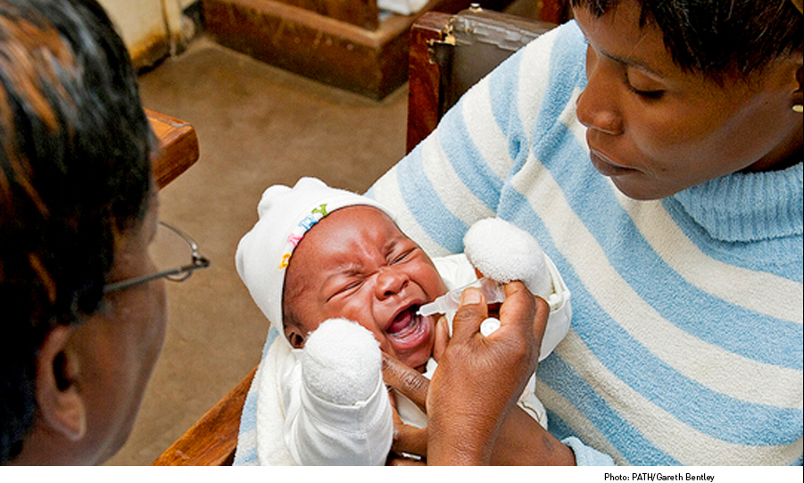 Teresa holds her son Vusi as he receives rotavirus vaccine